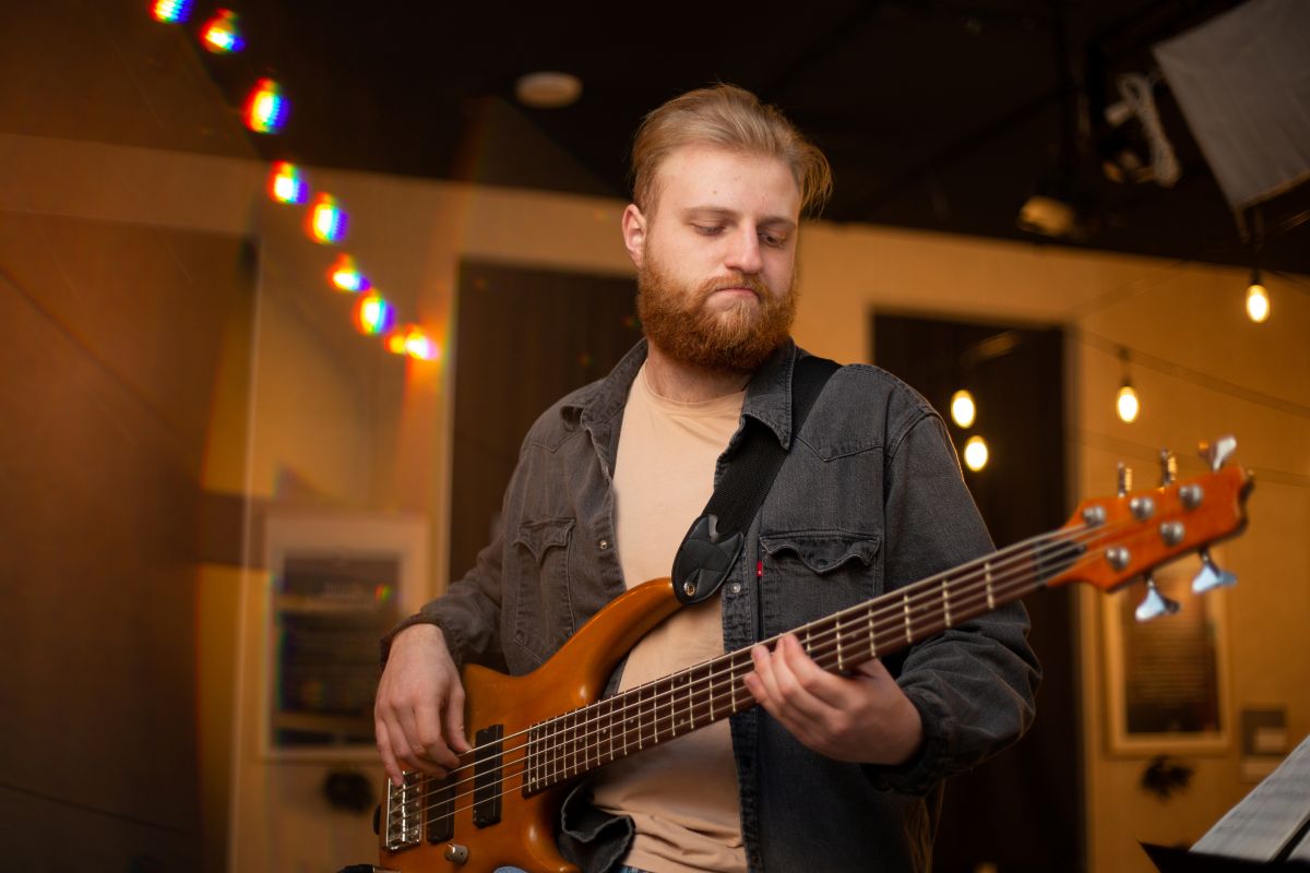 A male child taking private Bass Guitar lessons with a teacher